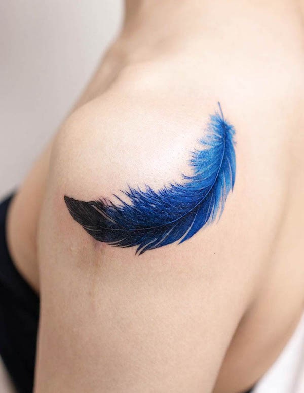 Tatuaggio di piume blu scuro di @pokhy_tattoo