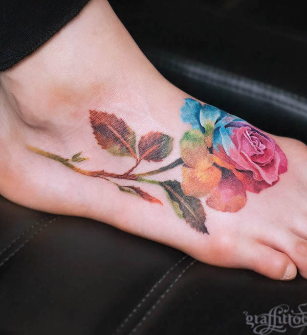 Tatuaggio del piede con rosa acquerellata di @graffittoo