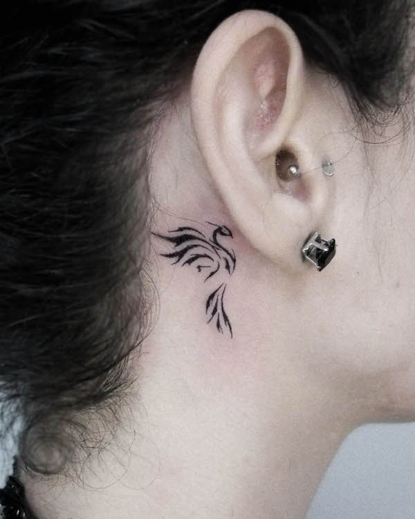 Tatuaggio della fenice dietro l'orecchio che simboleggia la crescita di @oztattoom