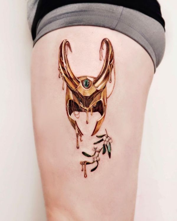 Tatuaggio con elmo di Loki e fiori di vischio di @chou_ta_1