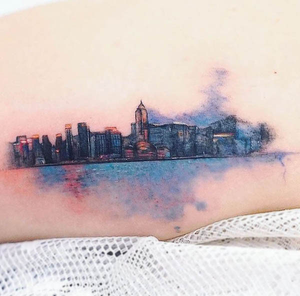 Tatuaggio con paesaggio urbano acquerellato di @minitattoo_studio