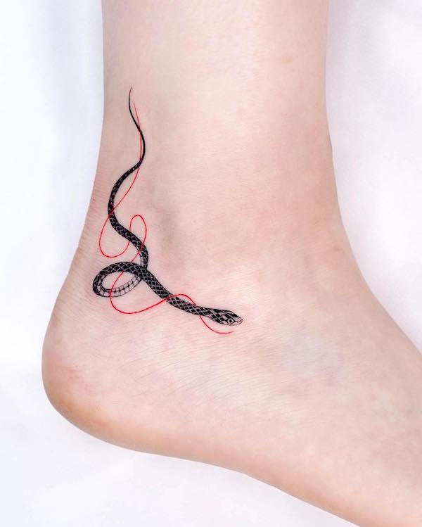 Tatuaggio alla caviglia con piccolo serpente by @bium_tattoo