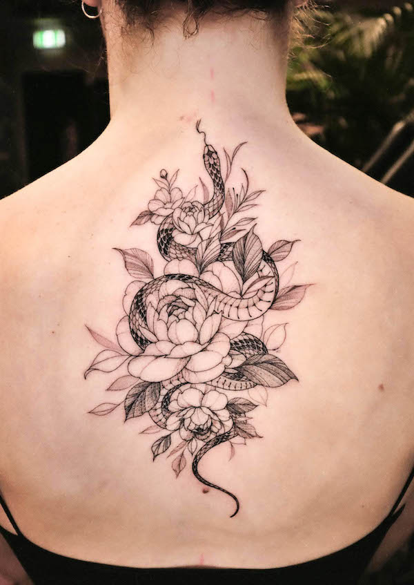 Intricato tatuaggio femminile con serpente e fiori sulla schiena by @miakim1984
