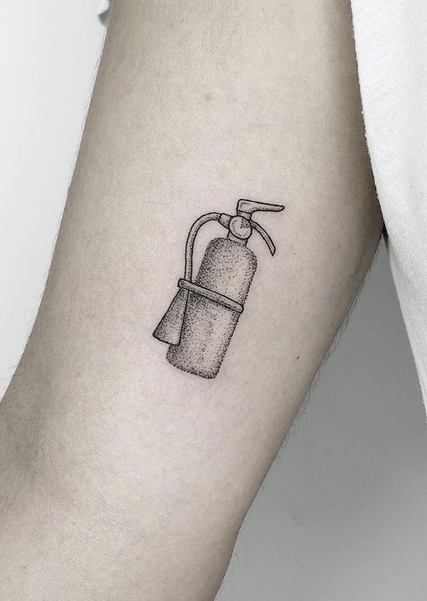 Piccolo estintore nero e grigio tatuato sul braccio da @dindottattoo