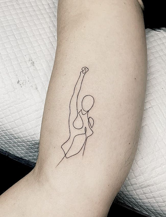 Empowering line art tattoo di @fine.line_.tattoos.melbourne